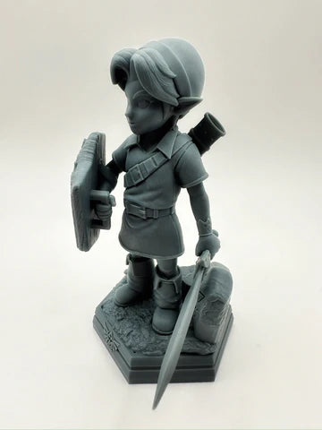 3D-printed chibi-style elf warrior with sword, shield, tunic and adventure gear on sculpted base, unpainted resin display miniature – Proxy Wargaming Australia.